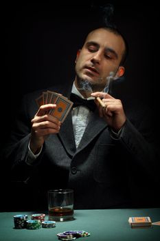 Portrait of a poker player over black background