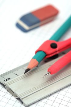 Close up of compasses, pencil, eraser and ruler