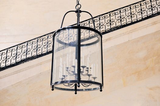 Antique lamp with candles in hall of the Louvre Museum