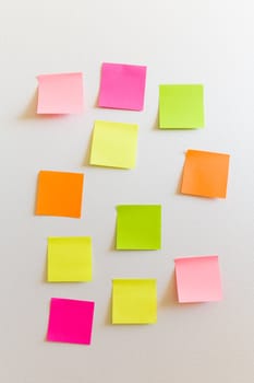 Blank sticky notes attached to a white wall.