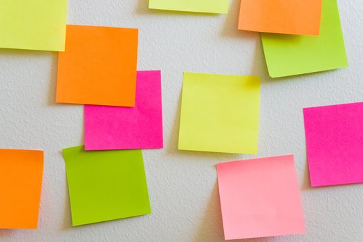 Blank sticky notes attached to a white wall.