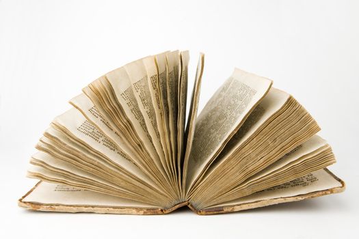 Open antique book on a white background