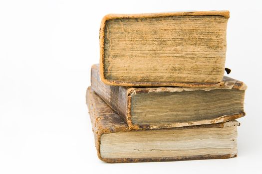 Antique books piled on a white background