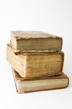 Antique books piled on a white background