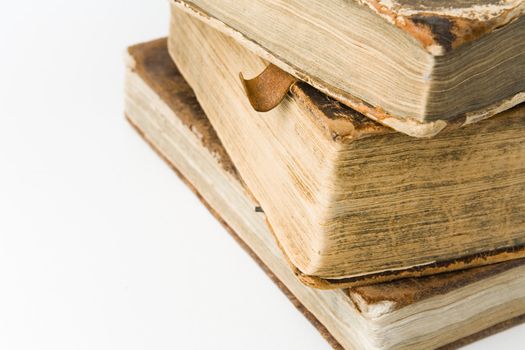 Antique books piled on a white background