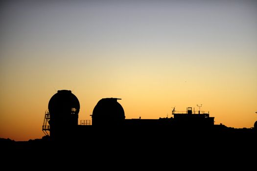 Astronomical observatory in mountains early in the morning.