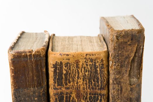 Row of antique books on a white background