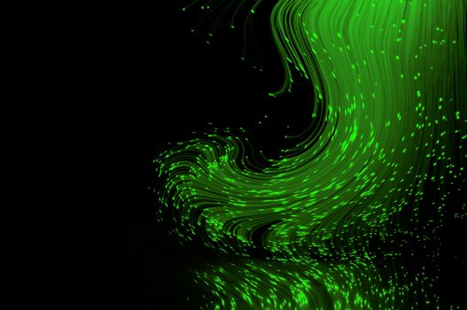 Bright green fiber optic light strands swirling against a black background and reflecting into the foreground.