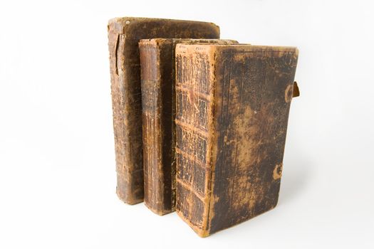 Row of antique books on a white background