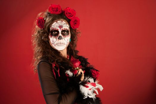 Rose bedecked lady posing in makeup for All Souls Day