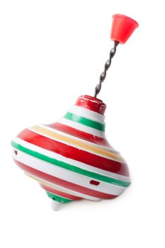 Aging plastic nursery whirligig with red handle on white background