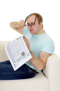 Funny man reading a job advertisement in the newspaper on white