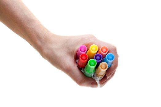 Colour soft-tip pens in feminine hand on deal background