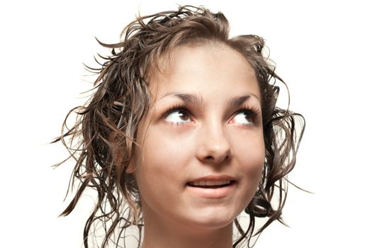 Beautiful girl with wet hair looks upwards, glance