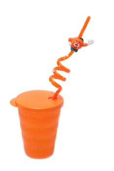 Plastic orange glass pipe for cocktail on white background