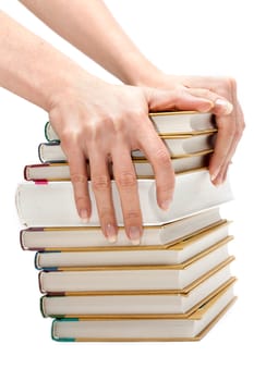 Feminine hands with manicure keeps pile of the books