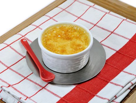 Red and white napkin with a home-made custard and its little red ceramic spoon