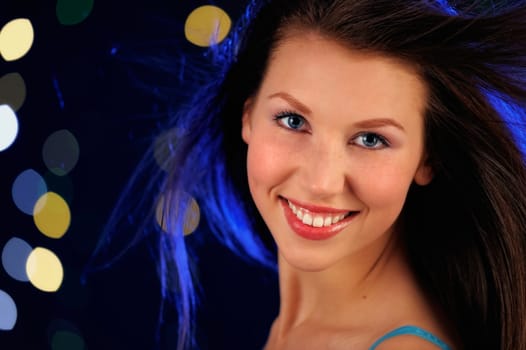 Young woman smiling. On the night disco