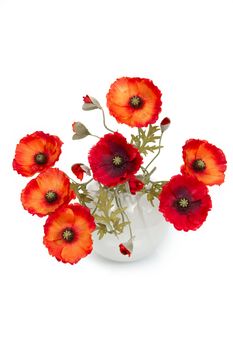 The image of a bouquet of artificial poppies in a vase, isolated, on a white background.