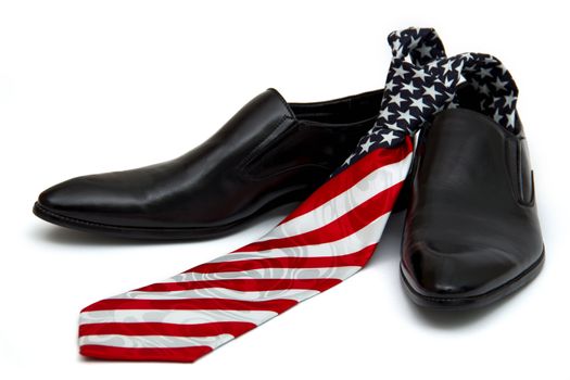 Black man's shoes and necktie with a coloring in style of a flag of America, on the white background, isolated