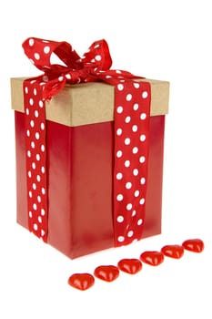 a present with a dotted ribbon and 6 hearts in the front