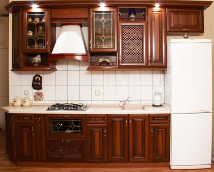 Modern kitchen an interior with эмитацией wood of valuable breeds and the built in illumination