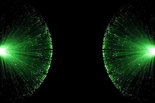Two groups of illuminated green fibre optic light strands eminating from the left and right image border against a black background