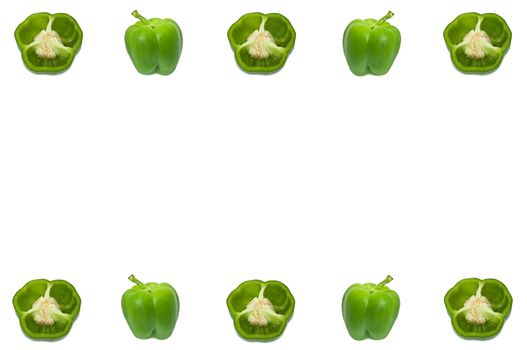 Several small halved and whole green peppers arranged along the border of the image over white.