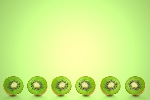 Six small kiwi fruit halves arranged in a horizontal line along the bottom of the image with green light effect filter background