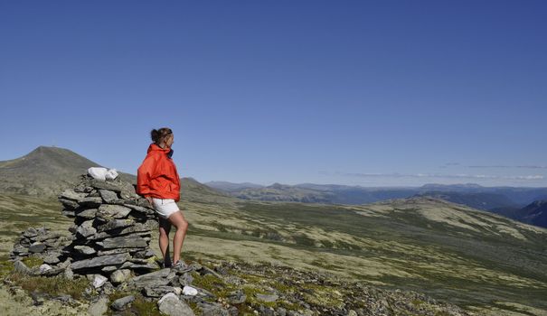 a woman in a norwegian mountain landscape