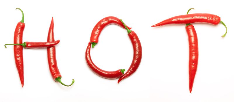 word HOT made from red peppers over white background