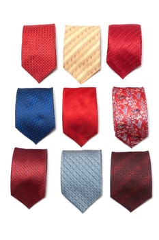 Varicoloured male ties convolute on white background
