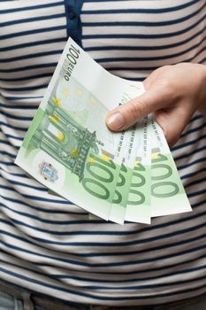 Persons gives bills euro on one hundred