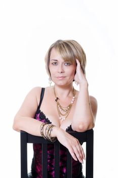 Studio portrait of a woman sitting on a chair isolated on white