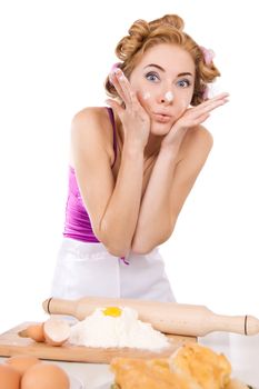 Worried housewife with rollers baking over white