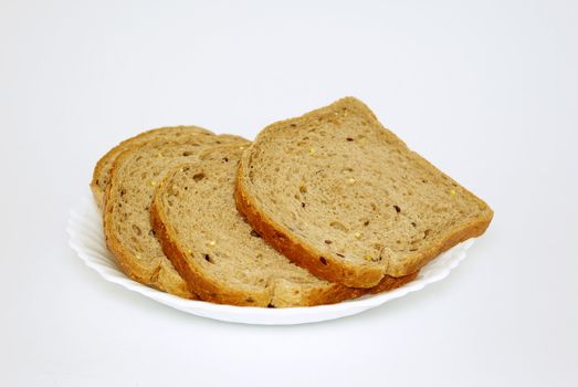 Pieces of bread on white plate