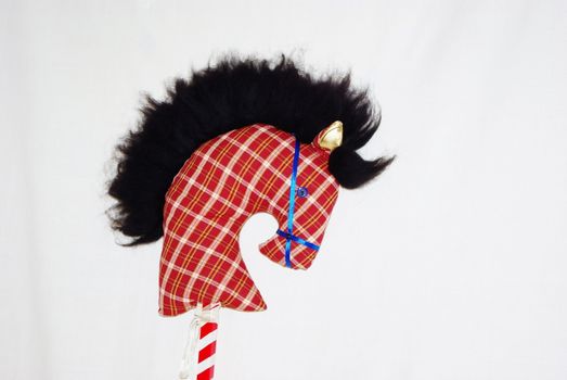 A homemade toy horse's head on a stick