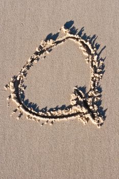 LetterQ drawn in the sand. 