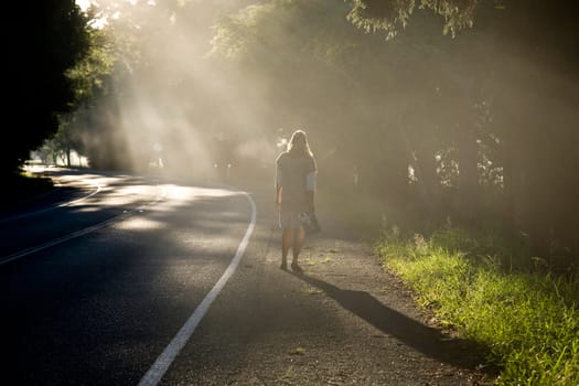 Woman roaming down a misty road. 