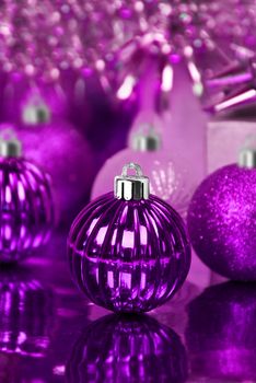 Purple christmas ornaments with star background