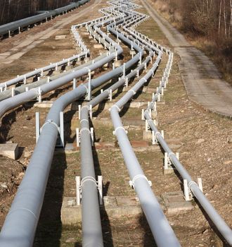 View of pipelines leading to the horizon with power-plant