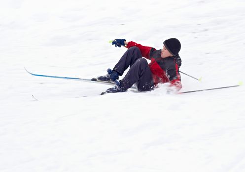 Cross country Skier fell on white snow