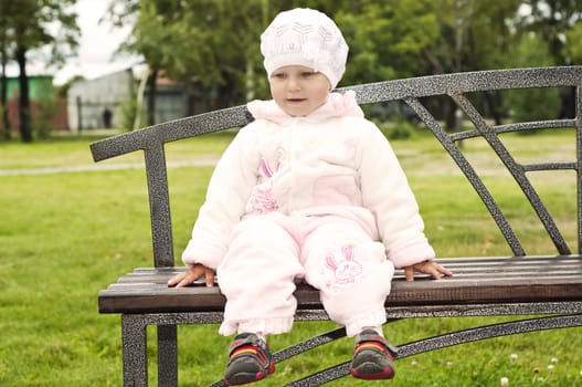 girls sitting on a park bench, spring park background