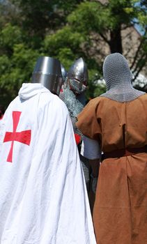 Arville,France,May 23rd 2010: Three Templar knights discussing during a Medieval Market which took place in Arville. Arville is the place where exist one of the best preserved Commanderie of Templars in France.