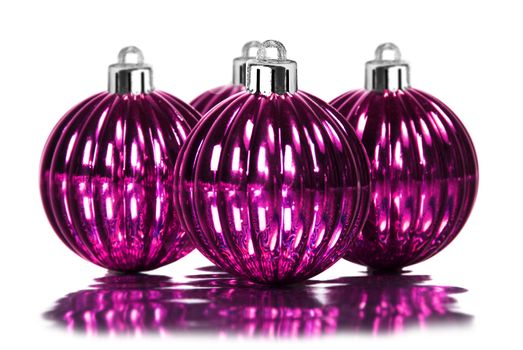 Pink christmas decoration baubles on white background