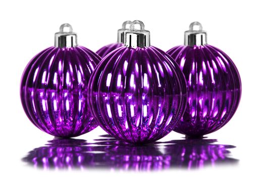 Purple christmas decoration baubles on white background