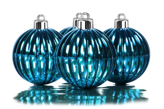 Blue christmas decoration baubles on a white background with space for text
