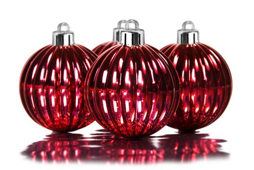 Red christmas decoration baubles on white background