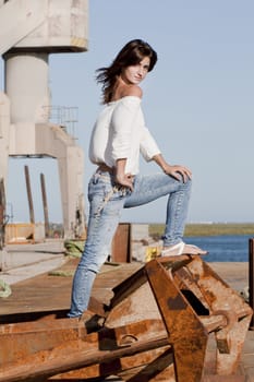 View of a beautiful girl posing on the docks.