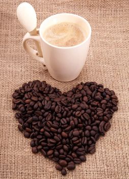 a coffee in the shape of heart  on canvas with cup